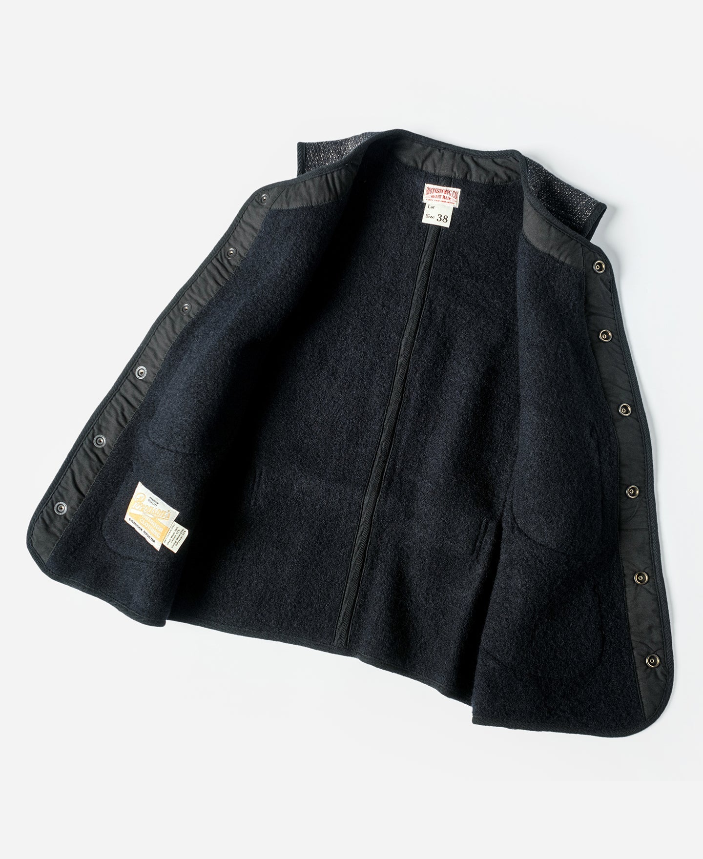 Gilet en laine mélangée poivre et sel à quatre poches avec liseré noir coupe classique