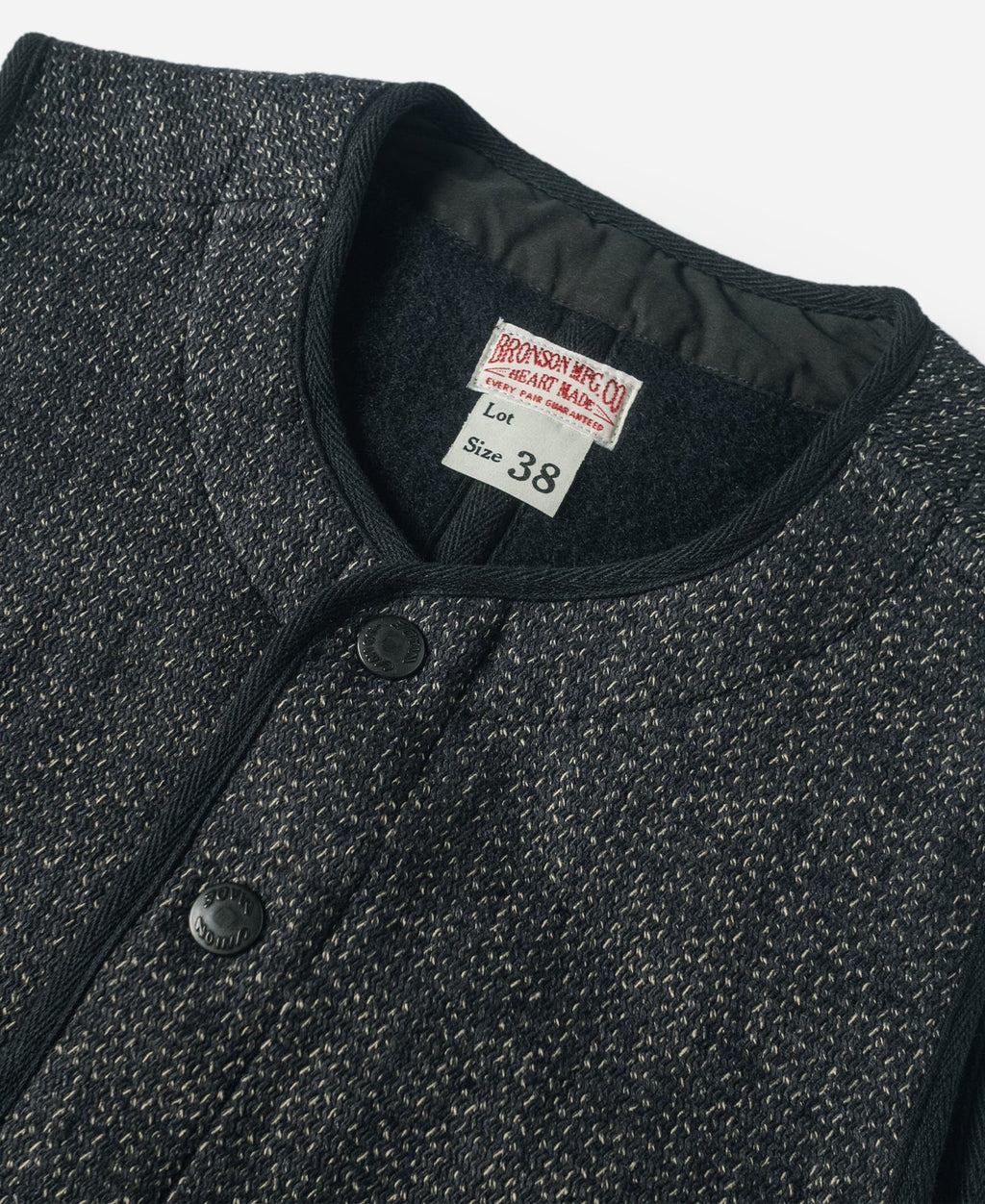 Gilet en laine mélangée poivre et sel à quatre poches avec liseré noir coupe classique